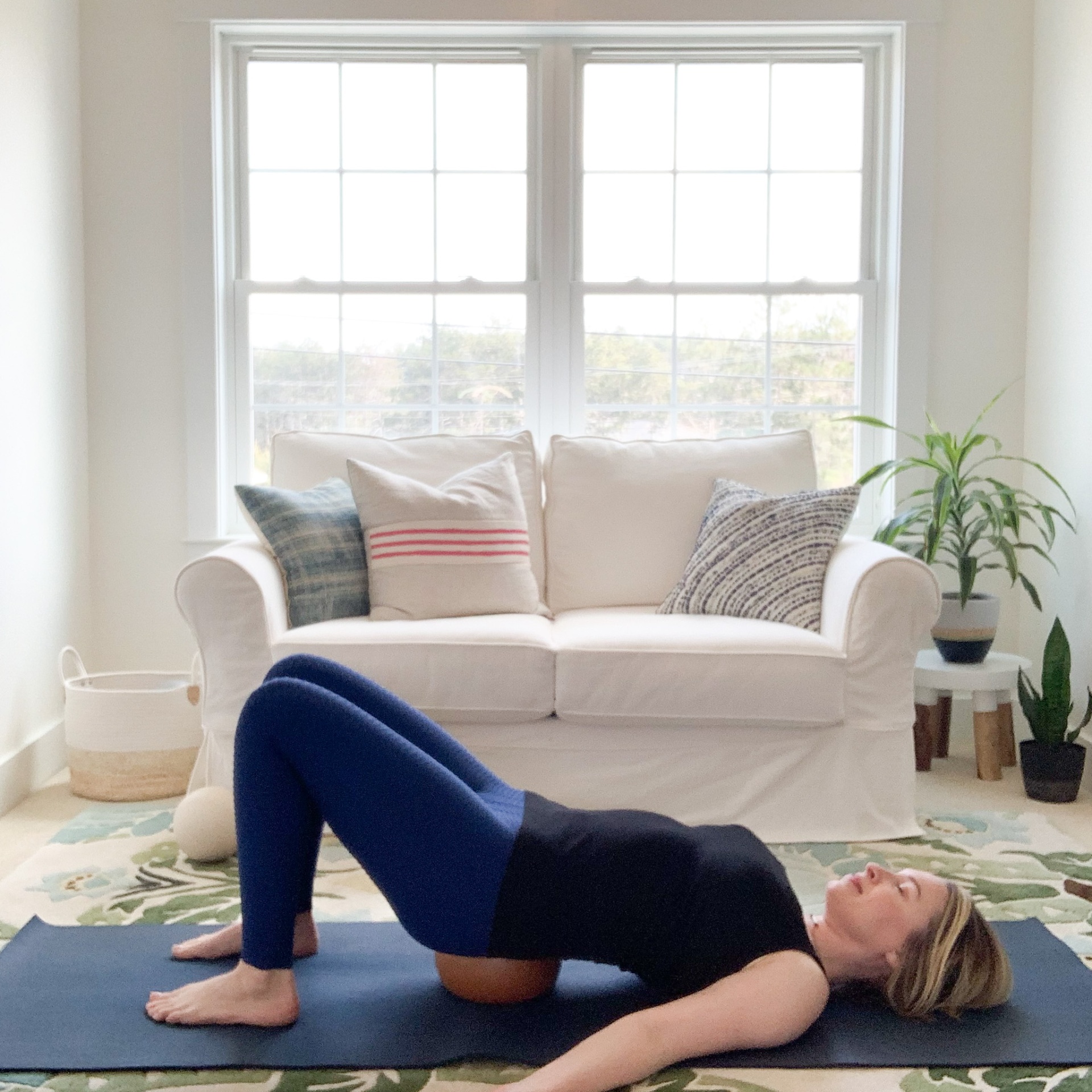 Maura practicing a supported bridge with a Yamuna ball at home
